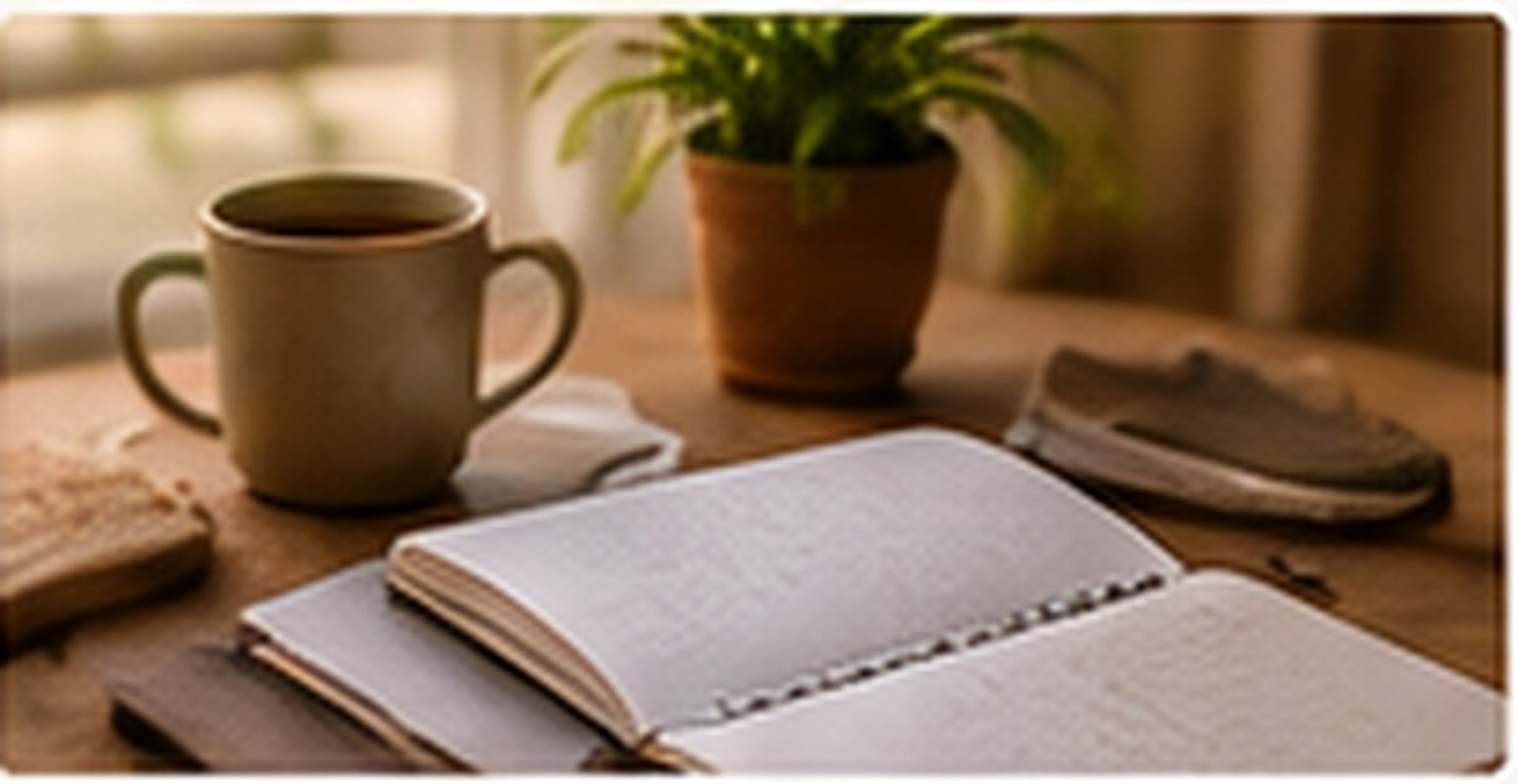A calm wellness journal beside tea and a plant